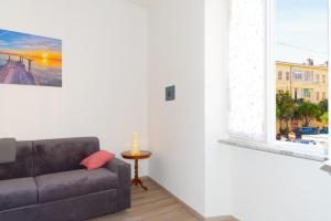 a living room with a couch and a window at Appartamento Al Mare in Portoferraio