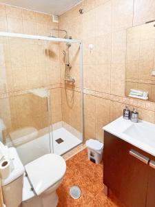 a bathroom with a shower and a toilet and a sink at CASA JARDIN DE MAR in Torrevieja