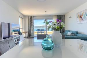 a living room with a vase with flowers on a counter at Villa A&D in Slatine