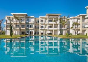 a swimming pool in front of a building at Appartement moderne CASABAY BEACH Sidi Rahal in Sidi Rahal
