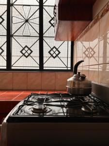 uma chaleira de chá numa placa de fogão na cozinha em ALAMEDAS APARMENTs em Pucallpa
