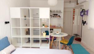 a room with a table and a white book shelf at Apartment Zlatko in Šibenik