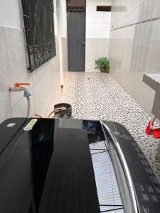 a car parked in a hallway with a tile floor at ALAMEDAS APARMENTs in Pucallpa