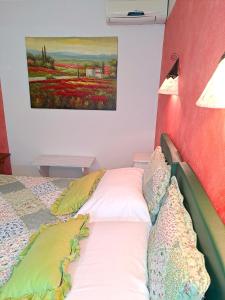 a bed in a room with a painting on the wall at Florivana Boutique Hotel Ristorante in San Pietro in Cariano