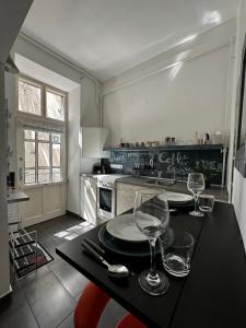 a kitchen with a table with wine glasses on it at Silverlight Luxus Downtown in Budapest