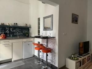 a kitchen with a counter and a stool and a mirror at Silverlight Luxus Downtown in Budapest