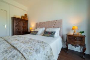 - une chambre avec un grand lit et une table de chevet en bois dans l'établissement Casa Pedro Porto, à Porto