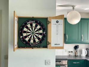 a dart board on a wall in a kitchen at Modern Spacious Apartment in Thornton Heath