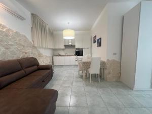 a living room with a couch and a table at Casa Vacanze Rosie in Cellamare +7 photos