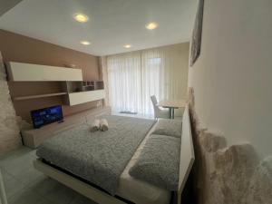 a bedroom with a bed with two shoes on it at Casa Vacanze Rosie in Cellamare