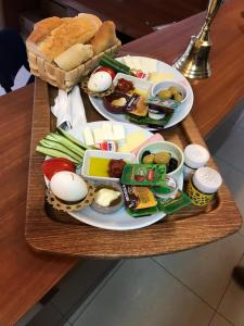 a tray of food with eggs and vegetables on a table at konak esila in Uşak