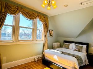 a bedroom with a bed and a large window at The Eden Hall Inn in Charlottetown