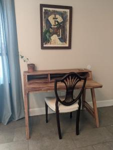 a wooden desk with a chair in front of it at Private Access Suite in Family Home in Orlando