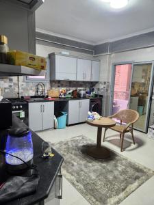 a kitchen with a table in the middle of a room at الامارات in Al Ma‘şarah