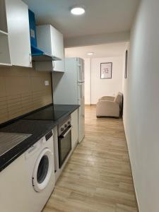 a kitchen with a washer and dryer in a room at Rooms Getafe in Getafe +42 photos