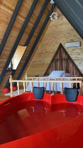 a room with two chairs and a bed in a attic at Azhara Bungalov in Pelitli