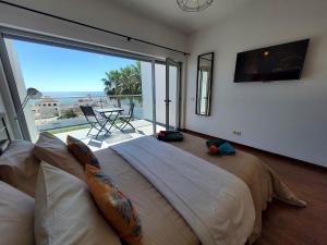 a bedroom with a large bed with a large window at Villa Amazing View - S in Albufeira