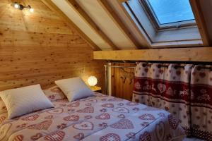 a bedroom with a bed in a wooden room at Estatico 1 - T2 duplex apartment sleeps 4 in Névache