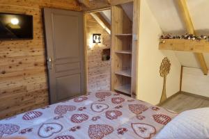 a bedroom with a bed with hearts on it at Estatico 1 - T2 duplex apartment sleeps 4 in Névache