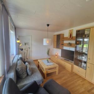 a living room with a couch and a table at Höher Auszeit- Bergisch schön in Wiehl