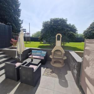a patio with a grill and a bench and a table at Höher Auszeit- Bergisch schön in Wiehl