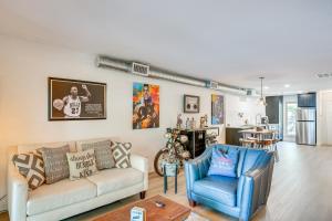 a living room with a couch and a blue chair at 7 Mi to Winery Lakefront Rockwall Home with Deck in Rockwall