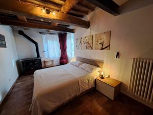 a bedroom with a large white bed and a window at B&B Ca Rossa in Cervia