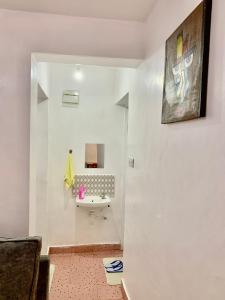 a bathroom with a sink and a mirror at Cozystay in Nakuru