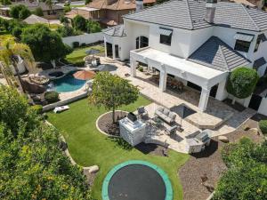 an aerial view of a house with a swimming pool at Two Separate Game Rooms, Heated Pool, Spa, B-ball Court in Mesa