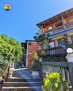 una casa con scale di fronte a un edificio di Pousada Ponta de Areia a Vila Velha
