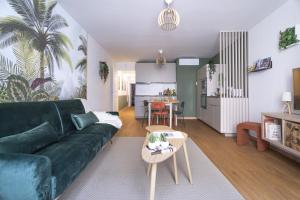 sala de estar con sofá verde y mesa en Le Palmae, appartement cosy, cœur de ville, climatisé, en Hyères