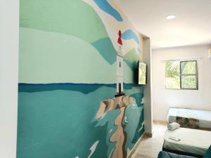 a room with a wall with a painting of a rocket at Avadia del Mar in Cartagena de Indias +39 photos