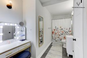 a white bathroom with a sink and a mirror at The Moose #11 - Luxe Modern loft with King Bed, Free Parking & Wi-Fi in Memphis