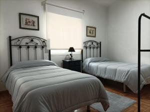 Posteľ alebo postele v izbe v ubytovaní Apartamento O Vento