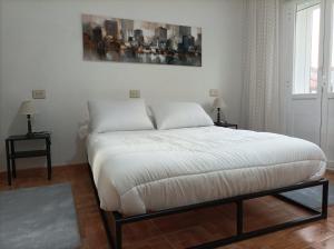 Posteľ alebo postele v izbe v ubytovaní Apartamento O Vento