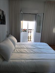 Posteľ alebo postele v izbe v ubytovaní Apartamento O Vento