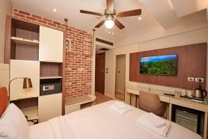 a bedroom with a bed and a ceiling fan at Saratoga Hotel Sultanahmet in Istanbul