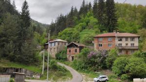 a group of buildings on a hill next to a road at Апартамент Извор 6 in Smolyan