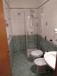 a bathroom with a shower and a toilet and a sink at Villa Dacla in Lampedusa