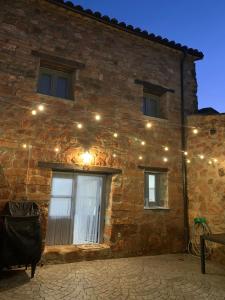 a brick building with lights on the side of it at La Casa Rural de Pálmaces in Pálmaces de Jadraque