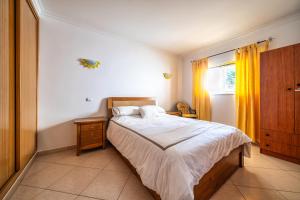 a bedroom with a bed and a window at Close to beach Alvor 1 bedroom apartment Villa da Praia AT08 in Alvor