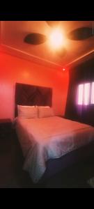 a bedroom with a bed with a red light at Hay Mohammadi agadir in Agadir