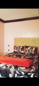 a bedroom with a bed with a red comforter at Hay Mohammadi agadir in Agadir