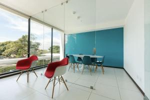 uma sala de jantar com mesa, cadeiras e janelas em Escape to this Rooftop Jacuzzi Apartment em Vuelta del Virilla