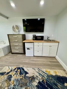 a kitchen with a sink and a tv on the wall at SKYLARANNA Resort & SPA in Hendersonville