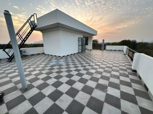 a building with a staircase and a checkered floor at Namastay farm in Jaipur