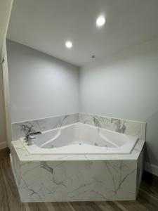 a white bath tub in a room with marble at SKYLARANNA Resort & SPA in Hendersonville
