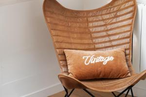 una silla con una almohada con la palabra vintage en Bleu de Chartres, en Chartres