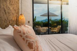 a bedroom with a bed with a view of a patio at Santuario Luxury Eco Hotel in Villeta +52 photos