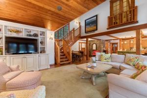 a living room with a couch and a tv and a table at Lake View Escape in Whitefish